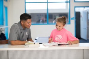 mentor and girl reading books together