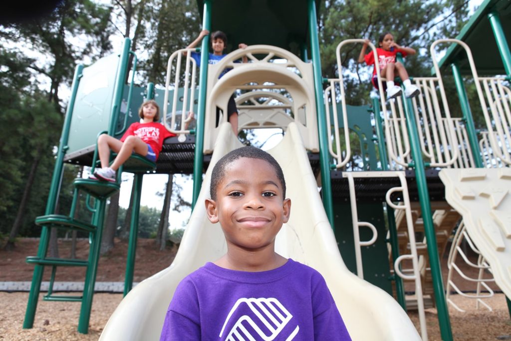 kids playing together in a jungle gym