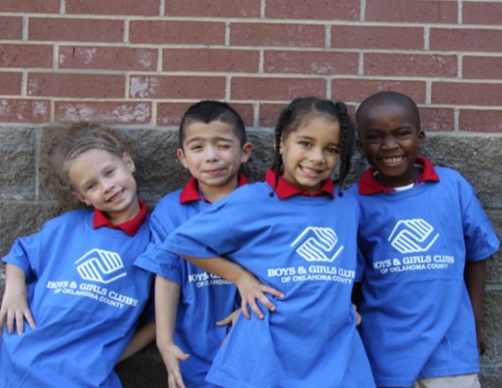 four kids smiling together